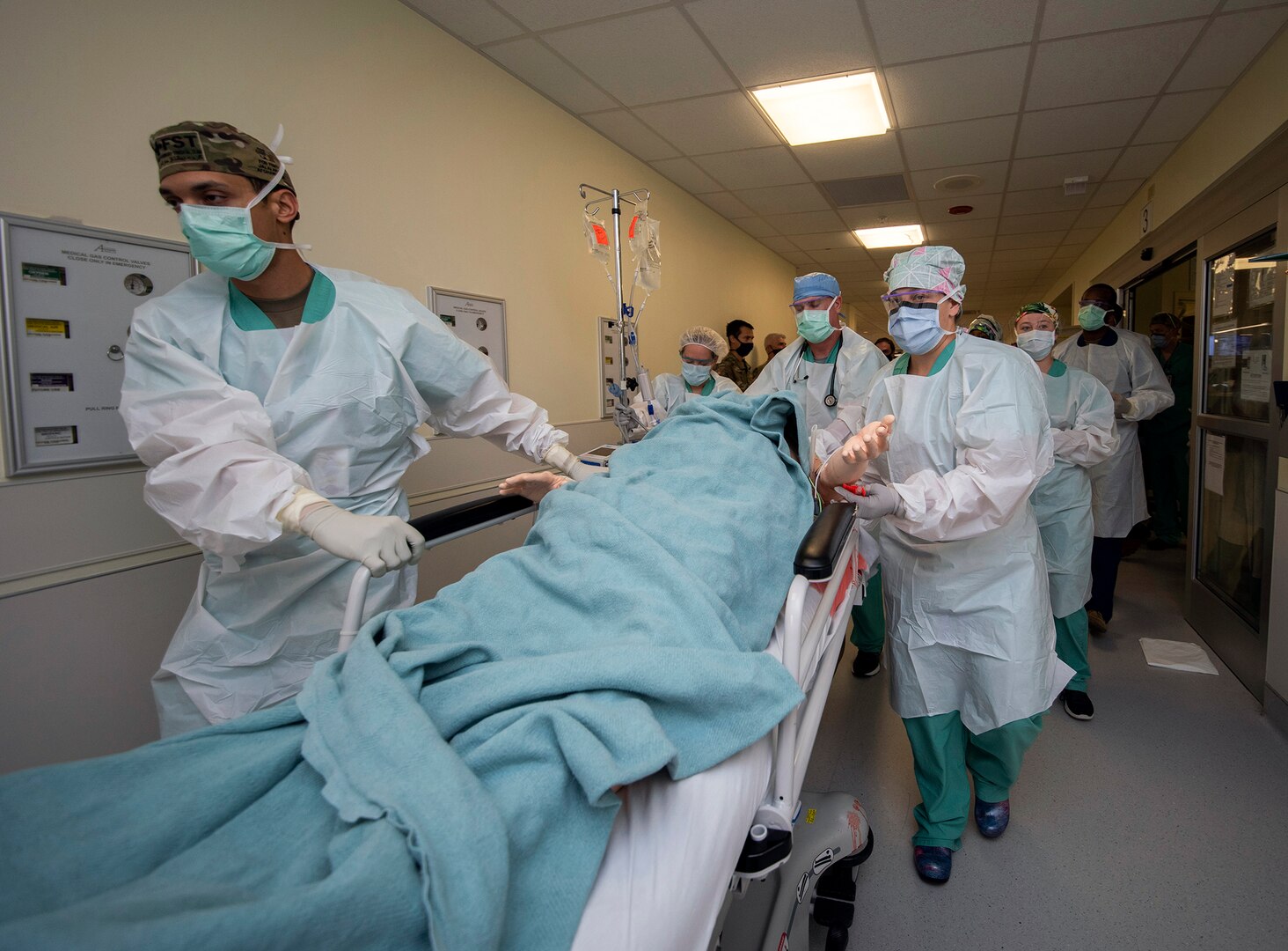 Members of the 555th Forward Surgical Team rush a simulated trauma patient to surgery during training with the Strategic Trauma Readiness Center of San Antonio, or STaRC, at Brooke Army Medical Center at Joint Base San Antonio-Fort Sam Houston, May 28, 2020.