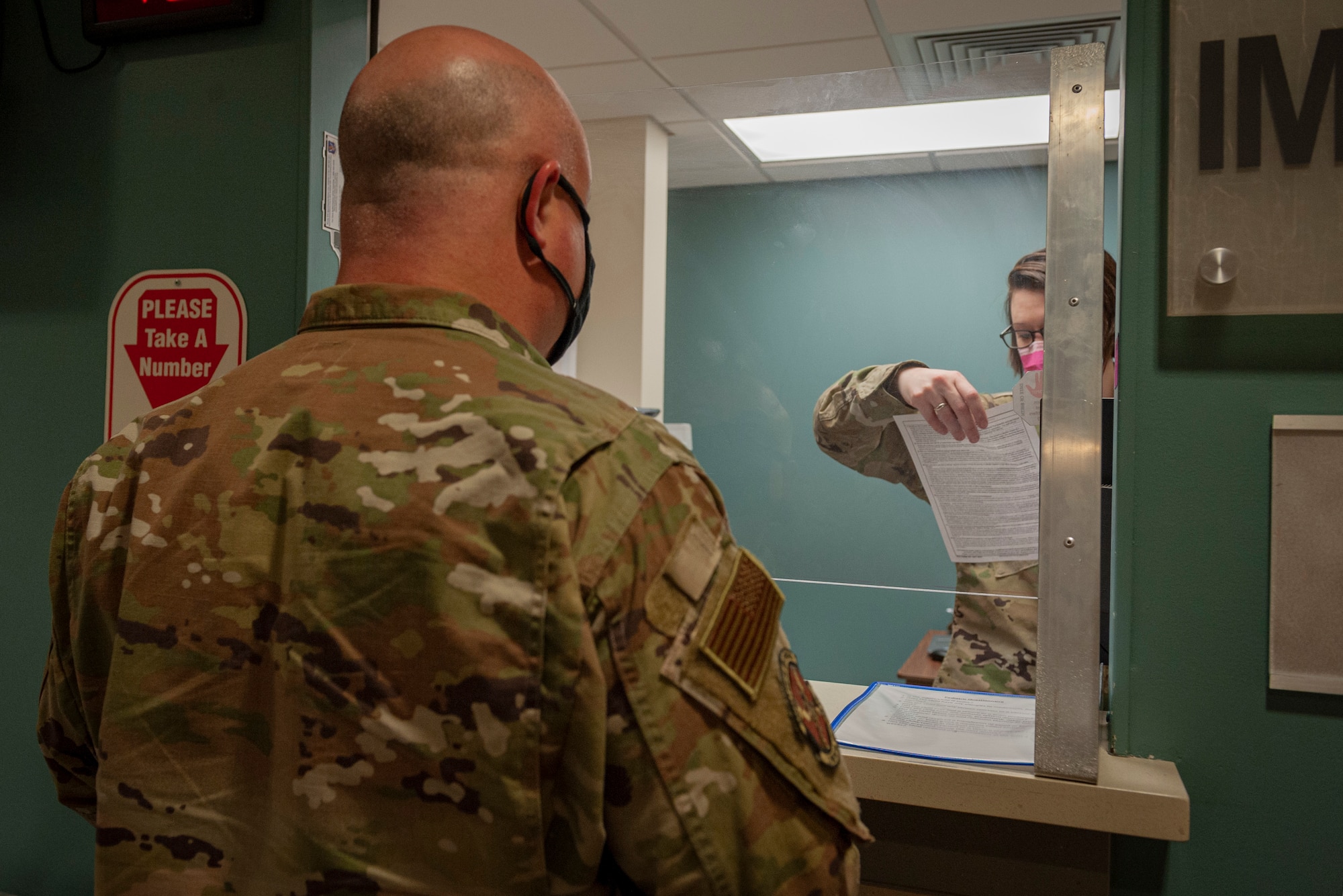 Photo of an Airman reviewing a patient's questionnaire