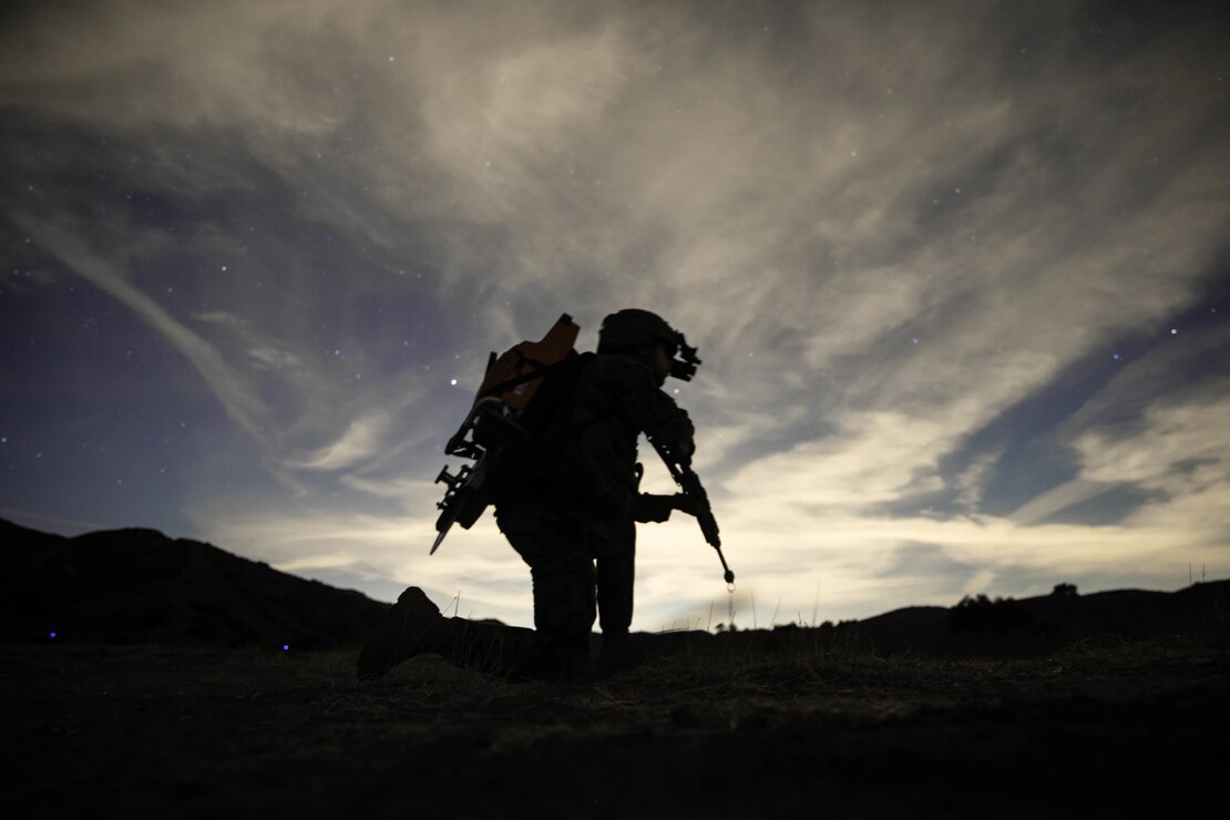U.S. Marine Corps Lance Cpl. Michael Wick, an aircraft rescue firefighter, with Marine Medium Tiltrotor Squadron (VMM) 165 (Reinforced), 11th Marine Expeditionary Unit, provides security during a Tactical Recovery of Aircraft and Personnel (TRAP) exercise at Marine Corps Base Camp Pendleton, California, Dec. 16, 2020. The purpose of the exercise was to familiarize the TRAP force with providing immediate response to isolated personnel in potential search and rescue situations, during both day and night scenarios. (U.S. Marine Corps photo by Sgt. Jennessa Davey)
