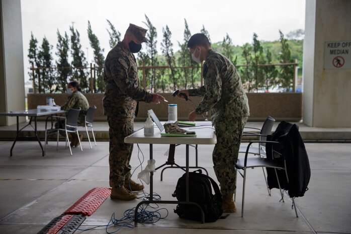 U.S. Marine Corps and Navy medical personnel and first responders complete an initial screening to receive the Moderna COVID-19 vaccine at the U.S. Naval Hospital Okinawa on Camp Foster, Okinawa, Japan, Dec. 29, 2020. The Department of Defense’s (DOD) COVID-19 vaccination plan is phase driven and designed to protect members within the DOD fromCOVID-19 as quickly and safely as possible in order to bolster mission readiness and enhance capabilities of DOD members worldwide. (U.S. Marine Corps photo by Lance Cpl. Alex Fairchild)
