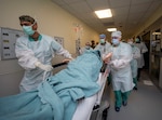 Members of the 555th Forward Surgical Team rush a simulated trauma patient to surgery during training with the Strategic Trauma Readiness Center of San Antonio, or STaRC, at Brooke Army Medical Center at Joint Base San Antonio-Fort Sam Houston, May 28, 2020.