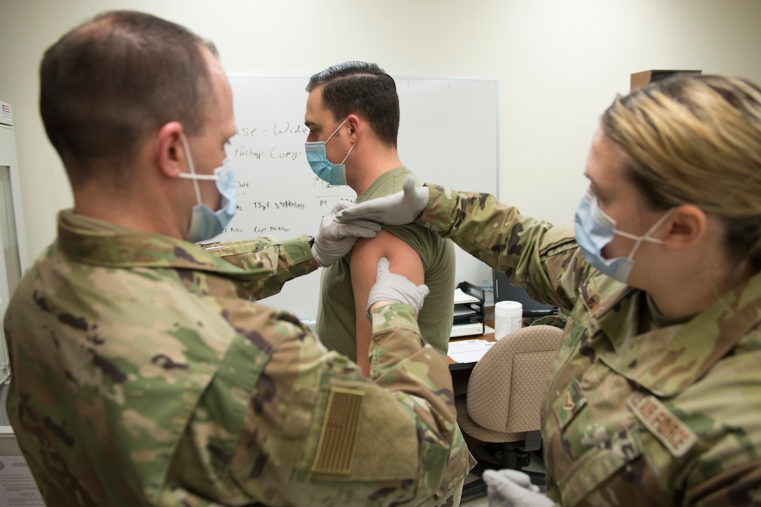 An airman gets vaccinated.