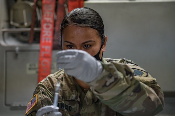 Image of an Airman drawing a vaccine.