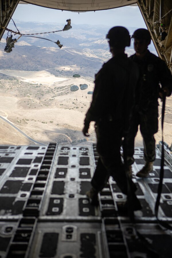 U.S. Marines with 1st Radio Battalion, I Marine Expeditionary Force Information Group, parachute down to the drop zone on Dec. 10, 2020, during a parachute exercise aboard a KC-130J Super Hercules at Marine Corps Base Camp Pendleton, California. The exercise allowed Marines of 1st Radio Battalion to practice an airborne deployment with cargo drops and static-line jumpers. (U.S. Marine Corps photo by Lance Cpl. Isaac Velasco)