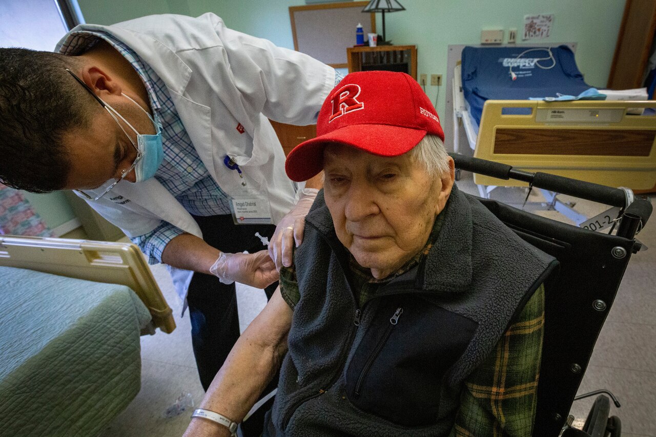 An older man gets vaccinated.