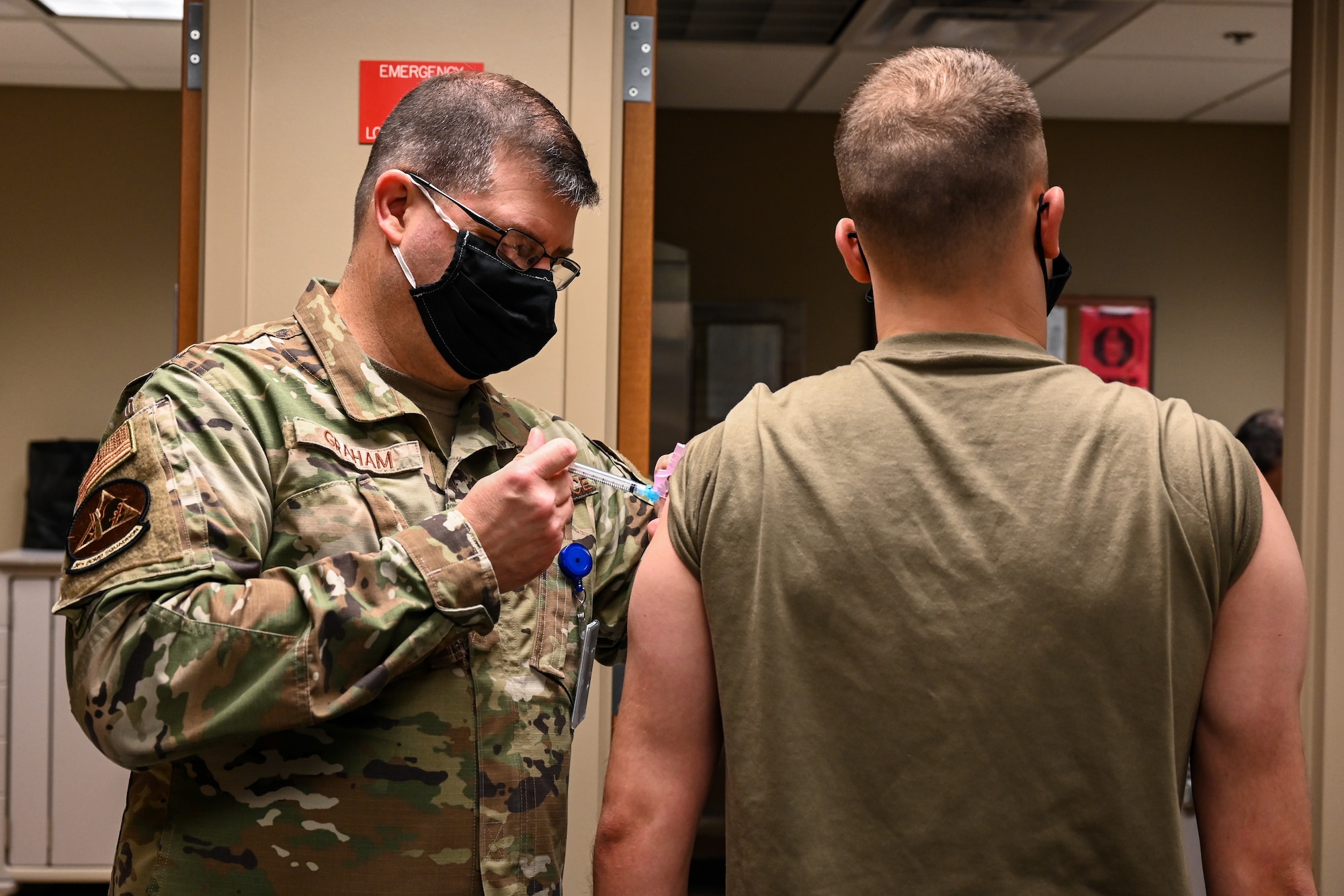 Airmen from the 2nd Medical Group receive the first doses of the COVID-19 vaccination at Barksdale Air Force Base, La., Jan. 6, 2021. Vaccination distribution prioritization within the Department of Defense will be consistent with data-driven guidance from the Centers for Disease Control and Prevention. (U.S. Air Force photo by Senior Airman Christina Graves)