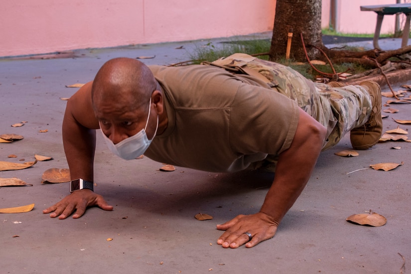 Lt. Col. Ronald Cole, Public Health Command-Pacific’s Human Health Services director and a public health nurse, does push-ups after receiving the first dose of the Pfizer vaccine at Tripler Army Medical Center, Honolulu, on Dec. 23, 2020. Cole explained that push-ups help relieve the side effect of having a sore arm after receiving a vaccine. He recommended that Soldiers do push-ups, if possible, if they normally tend to experience soreness after an inoculation. (U.S. Army photo by Amber E. Kurka)
