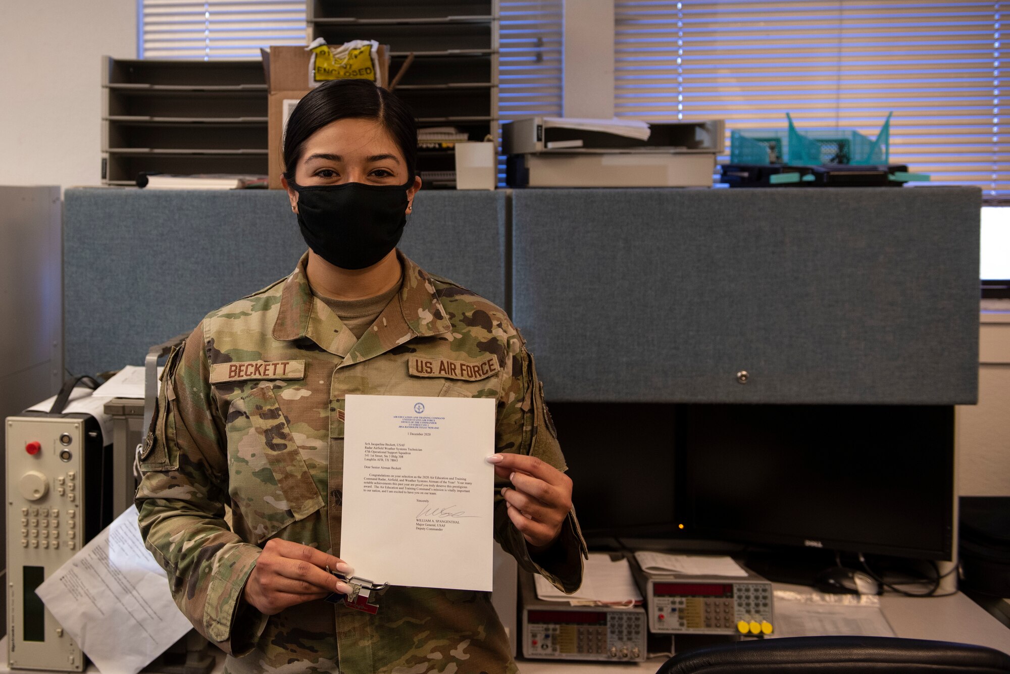 Senior Airman Jacqueline Beckett, 47th Operations Support Squadron radar airfield weather systems electronic technician, holds her letter of acknowledgement of being named Airman of the year in her career field in Air Education and Training Command, Jan. 7, 2021, at Laughlin Air Force Base, Texas. She is an Airman that always demonstrates the core values of the Air Force at all times. (U.S. Air Force photo by Airman 1st Class David Phaff)