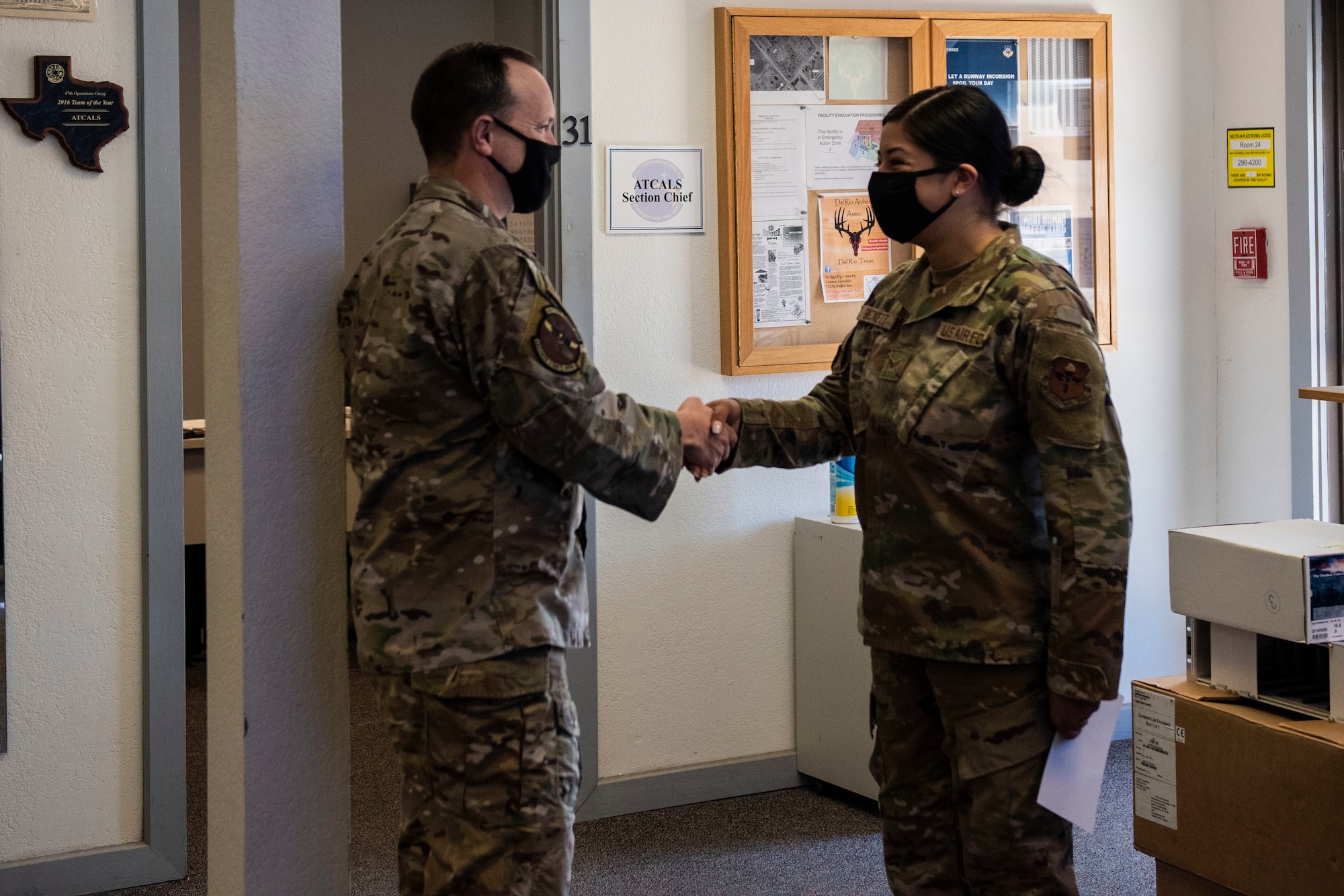 Col. Craig Prather, 47th Flying Training Wing commander, congratulates Senior Airman Jacqueline Beckett, 47th Operations Support Squadron radar airfield weather systems (RAWS) electronic technician, for achieving RAWS Airman of the year, Jan. 7, 2021, Laughlin Air Force Base Texas. Responsible for air traffic and warning radar systems, fixed and deployable navigational aids, weather equipment and radios, she ensures the equipment utilized by air traffic controllers and pilots remains in perfect working order.  (U.S. Air Force photo by Airman 1st Class David Phaff)