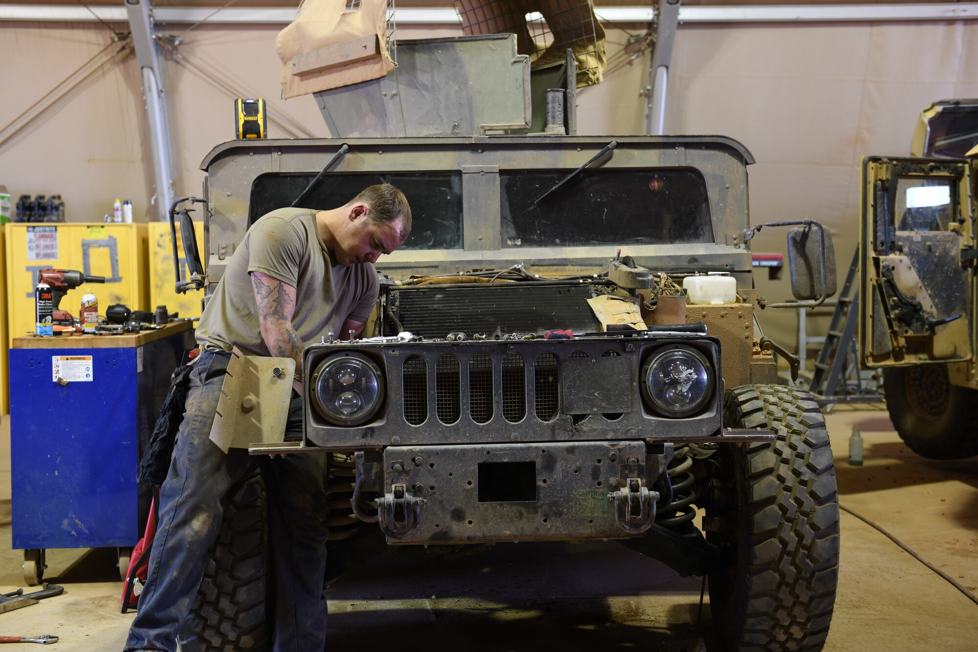 U.S. Air Force Staff Sgt. Jordan Arndt, 724th Expeditionary Air Base Squadron Logistics Readiness Flight heavy vehicle mechanic, services a Humvee to ensure that it is fully operational at Nigerien Air Base 201, Agadez, Niger, Jan. 4, 2021. Vehicle Maintenance performs regular maintenance on government owned vehicles and equipment around the base. (U.S. Air Force photo by Senior Airman Gabrielle Winn)