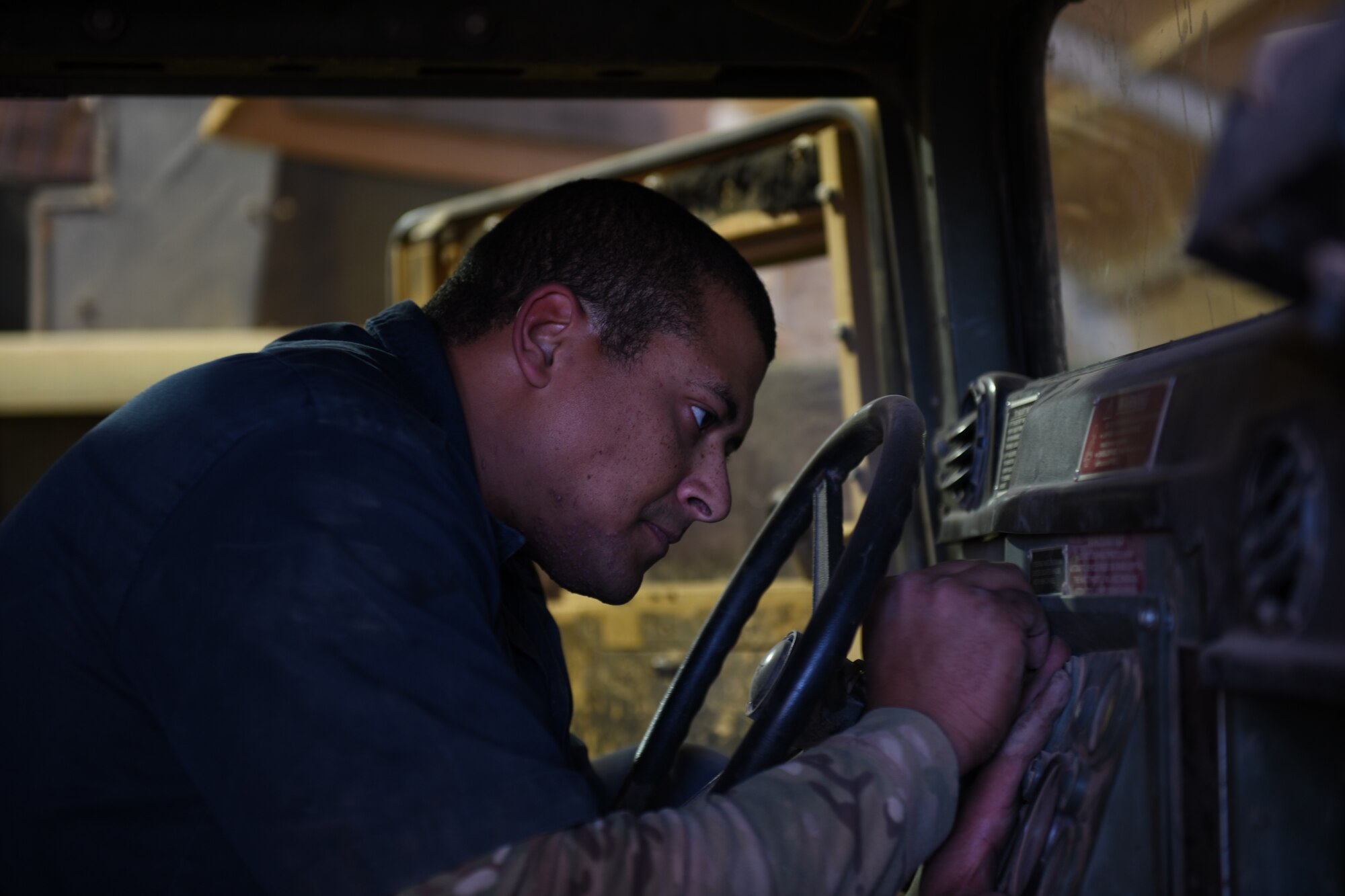 U.S. Air Force Staff Sgt. Joshua Poole, 724th Expeditionary Air Base Squadron noncommissioned officer in charge of materiel management, places a control panel inside a Humvee, at Nigerien Air Base 201, Agadez, Niger, Jan. 4, 2021. Materiel management consists of continuing actions relating to planning, organizing, directing, coordinating, controlling, and evaluating the application of resources to ensure the effective and economical support of military forces. (U.S. Air Force photo by Senior Airman Gabrielle Winn)