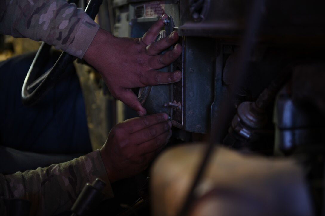 U.S. Air Force Staff Sgt. Joshua Poole, 724th Expeditionary Air Base Squadron noncommissioned officer in charge of materiel management, inserts a control panel inside a Humvee, at Nigerien Air Base 201, Agadez, Niger, Jan. 4, 2021. No matter what the needs are of the Air Force, Air Force Materiel Management personnel make sure Airmen get the critical supplies needed to keep the mission going. (U.S. Air Force photo by Senior Airman Gabrielle Winn)