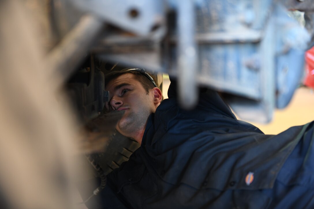 U.S. Air Force Staff Sgt. Colt Sutter, 724th Expeditionary Air Base Squadron vehicle maintenance craftsman, secures a bolt on the axle of a Humvee, at Nigerien Air Base 201, Agadez, Niger, Jan. 4, 2021.  Airmen in vehicle operations performs and manages vehicle operations functions and activities to include dispatching, operating, and servicing motor vehicles such as general and special purpose, base maintenance, and material handling vehicles. (U.S. Air Force photo by Senior Airman Gabrielle Winn)
