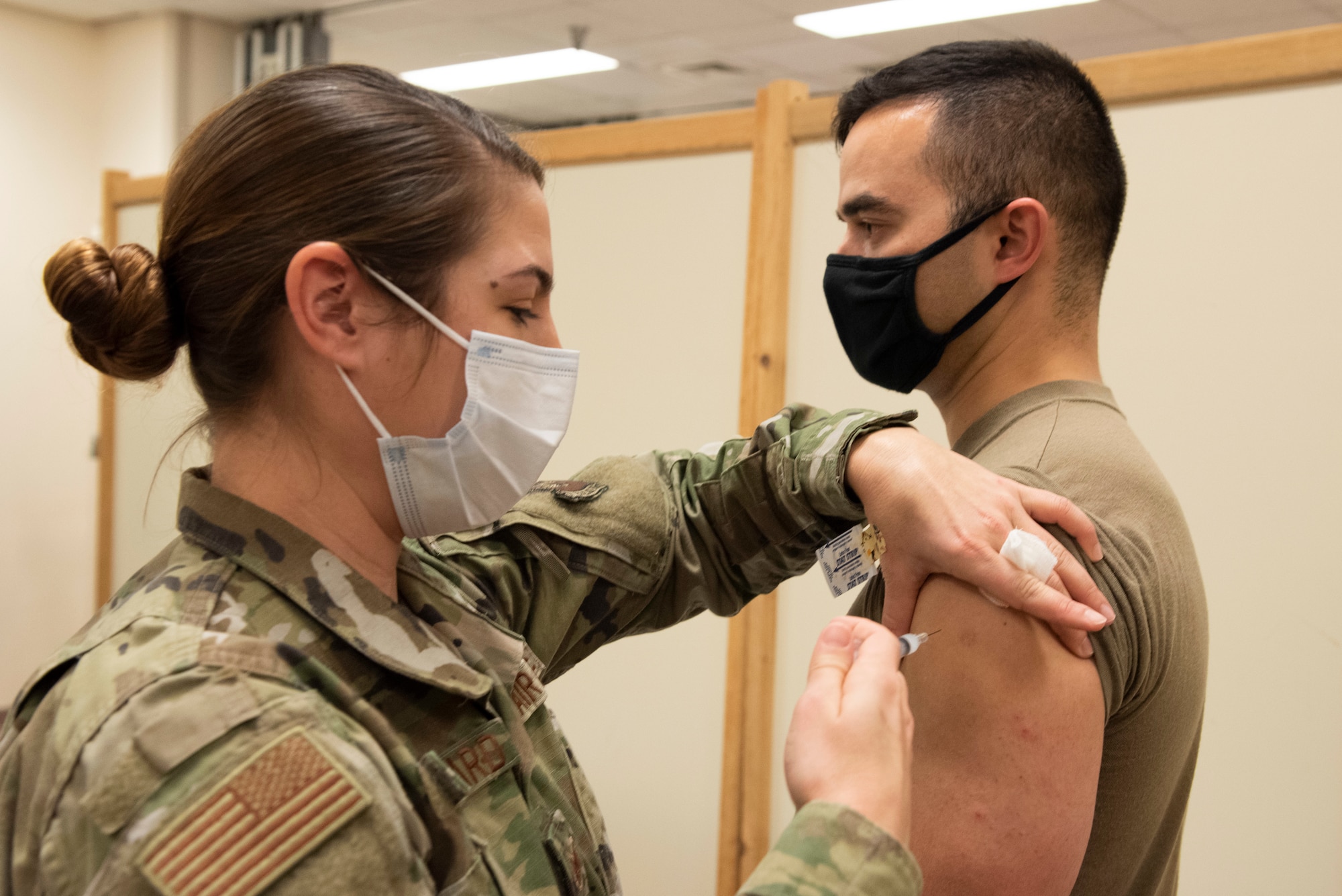 Female medic administering a vaccine