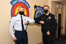 Maj. Shane Watts, 66th Security Forces Squadron commander, bumps elbows with Cpl. Bernardino Coelho, 66 SFS lead police officer, at Hanscom Air Force Base, Mass., Jan. 4. Coelho was recently named the 2020 Flight Level Civilian Employee (Supervisor) for the security forces career field. (U.S. Air Force photo by Mark Herlihy)