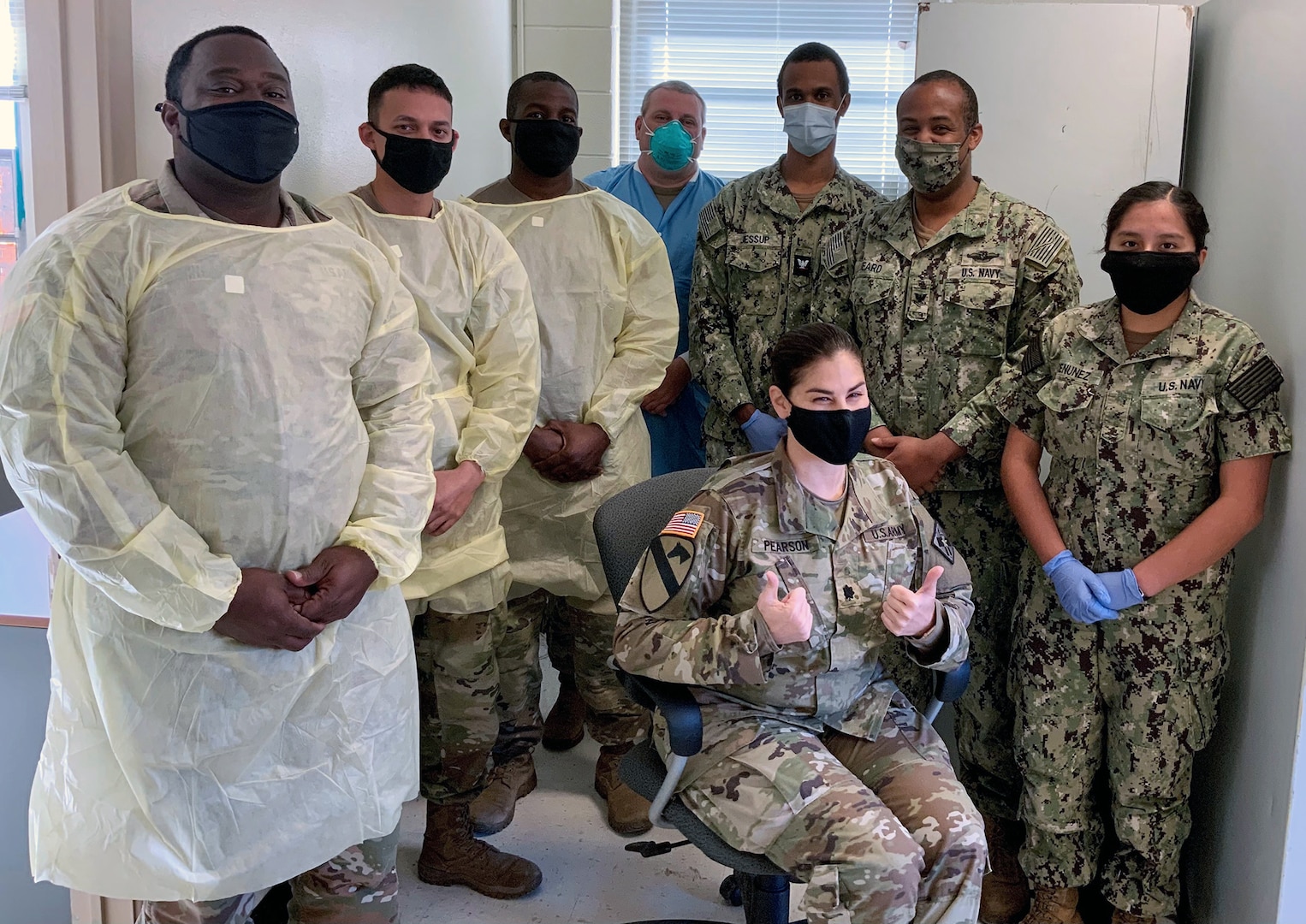 Lt. Col. Nadia M Pearson, U.S. Army Medical Center of Excellence command surgeon (seated) poses for a group photo with members of the Holiday Block Leave Team Reintegration Testing Cell.