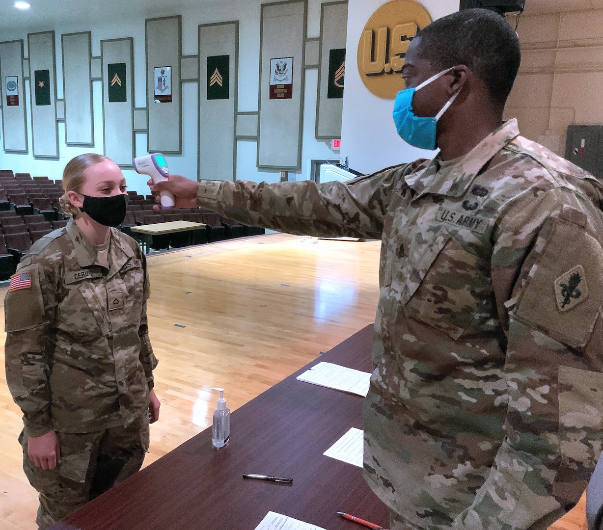 Staff Sgt. Michael White, an instructor with the 187th Medical Battalion, takes Pfc. Amaya Cerutti’s temperature after she returned from Holiday Block Leave.