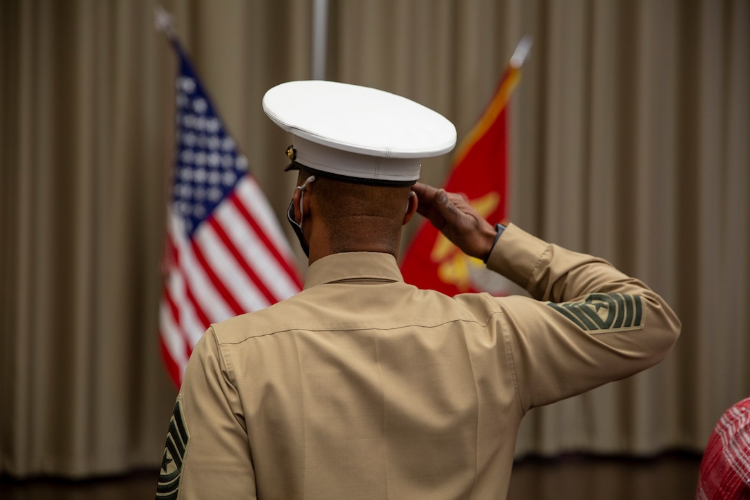 U.S. Marine Sgt. Maj Chester Wilson III salutes the flag during the playing of the national anthem as part of a relief and appointment ceremony at the Defense Logistics Agency, New Cumberland, Pennsylvania, Dec. 22, 2020. Sgt. Maj. Kenneth. L. Kuss took over  the 4th Marine Corps District seanior enlisted advisor position from Wilson. (U.S. Marine Corps photo by Gunnery Sgt. Valerie Nash)