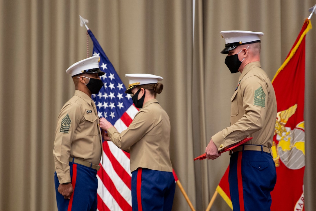 U.S. Marine Col. Heather J. Cotoia, center, commanding officer, 4th Marine Corps District, pins a medal on Sgt. Maj Chester Wilson III, left, outgoing district sergeant major, during a relief and appointment ceremony at the Defense Logistics Agency, New Cumberland, Pennsylvania, Dec. 22, 2020. Sgt. Maj. Kenneth L. Kuss took over as the 4th Marine Corps District senior enlisted advisor position from Wilson. (U.S. Marine Corps photo by Gunnery Sgt. Valerie Nash)