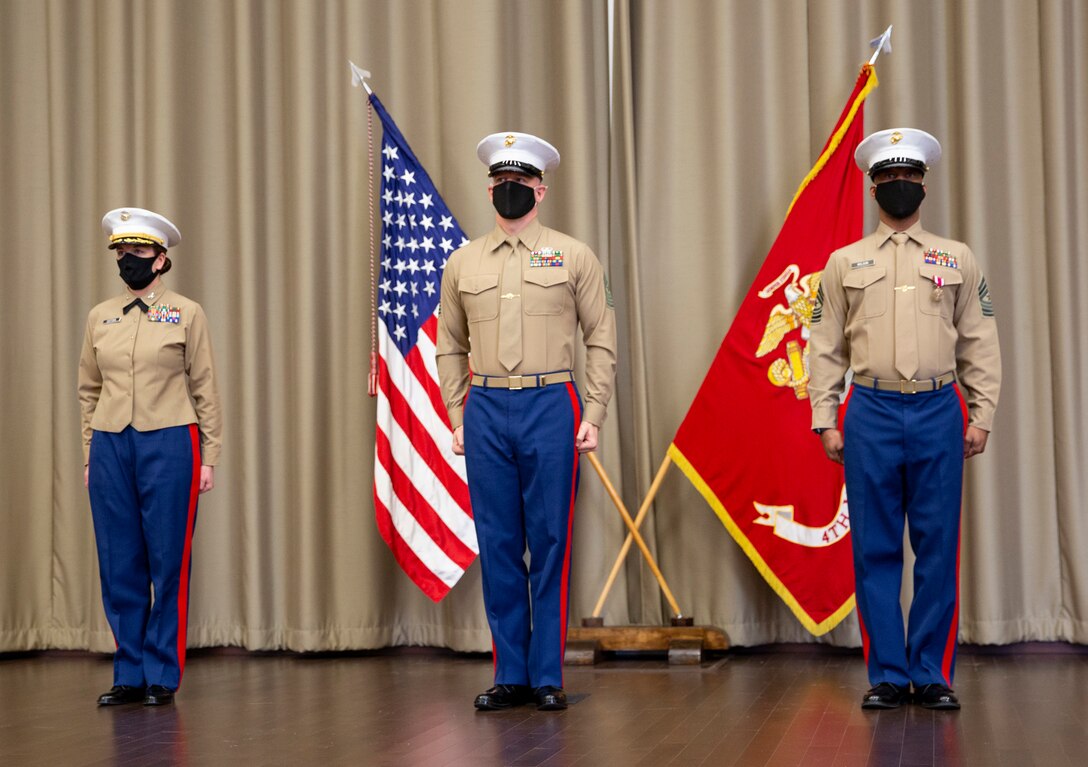 U.S. Marines Col. Heather J. Cotoia, left, Sgt. Maj. Kenneth L. Kuss , center, and Sgt. Maj. Chester Wilson III stand at attention for the Marine Corps Hymn during a relief and appointment ceremony at the Defense Logistics Agency, New Cumberland, Pennsylvania, Dec. 22, 2020. Kuss took over the 4th Marine Corps District senior enlisted advisor position from Wilson. (U.S. Marine Corps photo by Gunnery Sgt. Valerie Nash)