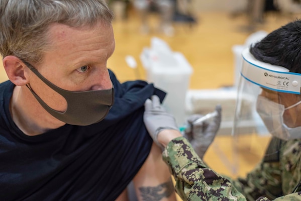 Cmdr. Andrew Wiese receives the COVID-19 vaccine on Commander, Fleet Activities Yokosuka (CFAY).