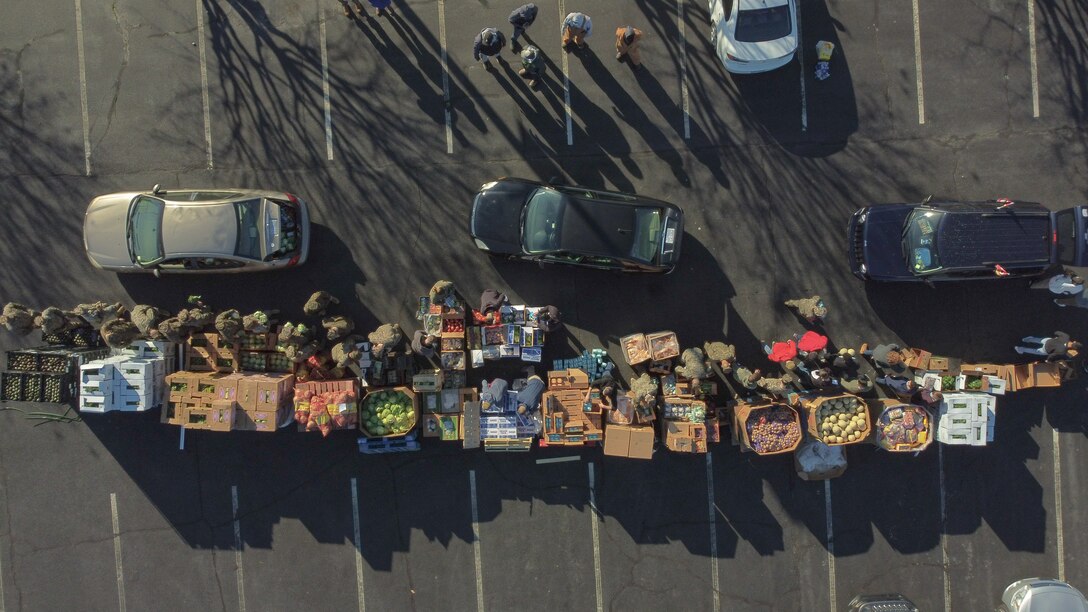U.S. Marines with II Marine Expeditionary Force volunteer at a food drive at the Historic Grainger Stadium parking lot in Kinston, North Carolina, Dec. 29, 2020. The event hosted by the Clinical Resourceful Laboratory, ADLA and the City of Kinston, provided residents of Kinston a free box of food and COVID- 19 testing.(U.S. Marine Corps photo by Cpl. Jonathan Hodges)