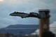 Photo of an A-10 Thunderbolt II flying across the Davis-Monthan Air Force Base air traffic control tower