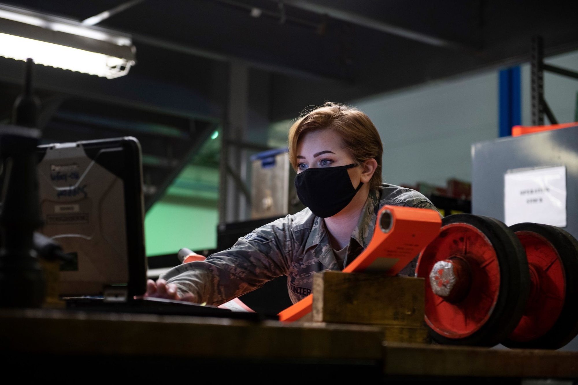 Airman 1st Class Hannah Kinter, 9th Aircraft Maintenance Squadron (AMXS) support technician, reviews technical orders prior to conducting maintenance on a U-2 Dragon Lady pogo-wheel assembly on Beale Air Force Base.