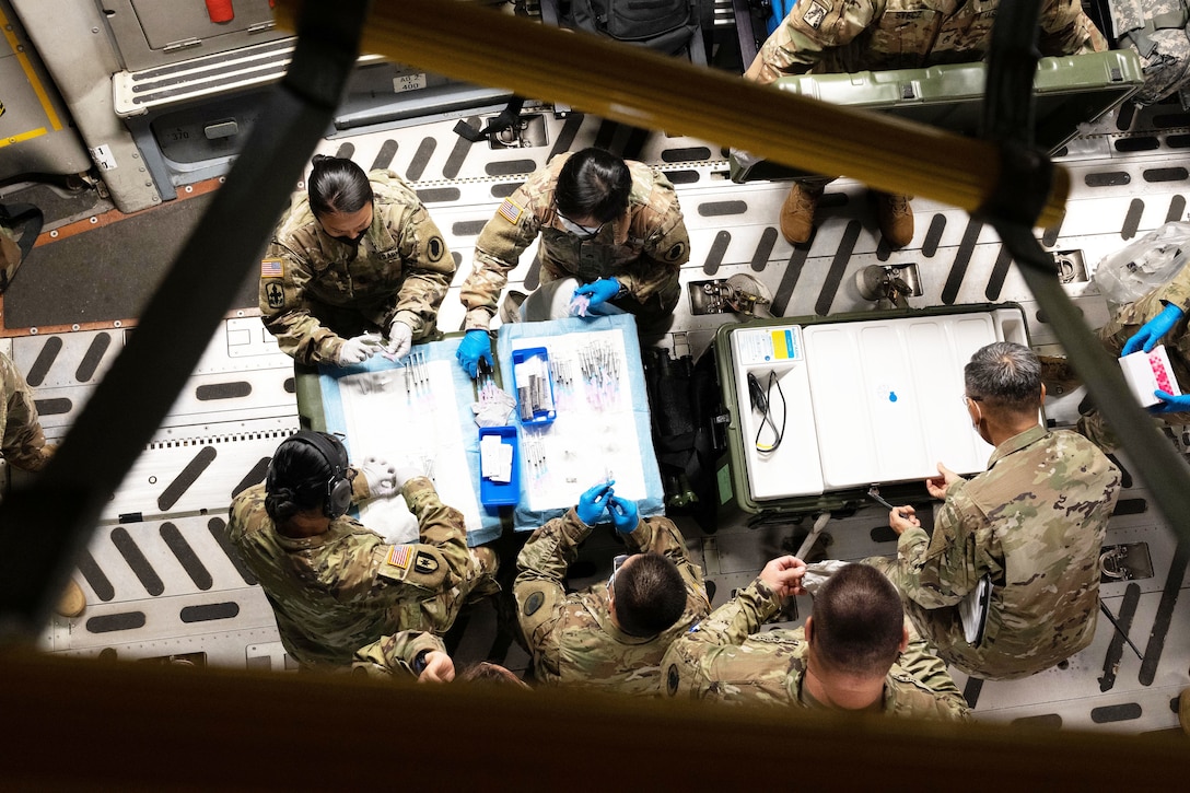 A group of National Guardsmen are seen from above seated around tables.