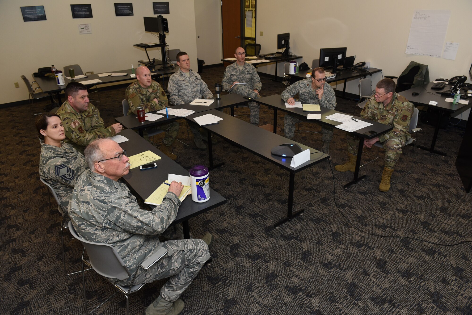 A crisis action team comprised of key members of the Wisconsin Air National Guard's 115th Fighter Wing engage in a conference call at Truax Field in Madison, Wisconsin, March 20, 2020. The 115th FW initiated a daily CAT operation on March 18 in preparation to support local authorities in the response to the COVID-19 pandemic. (U.S. Air National Guard photo by Master Sgt. Paul Gorman)