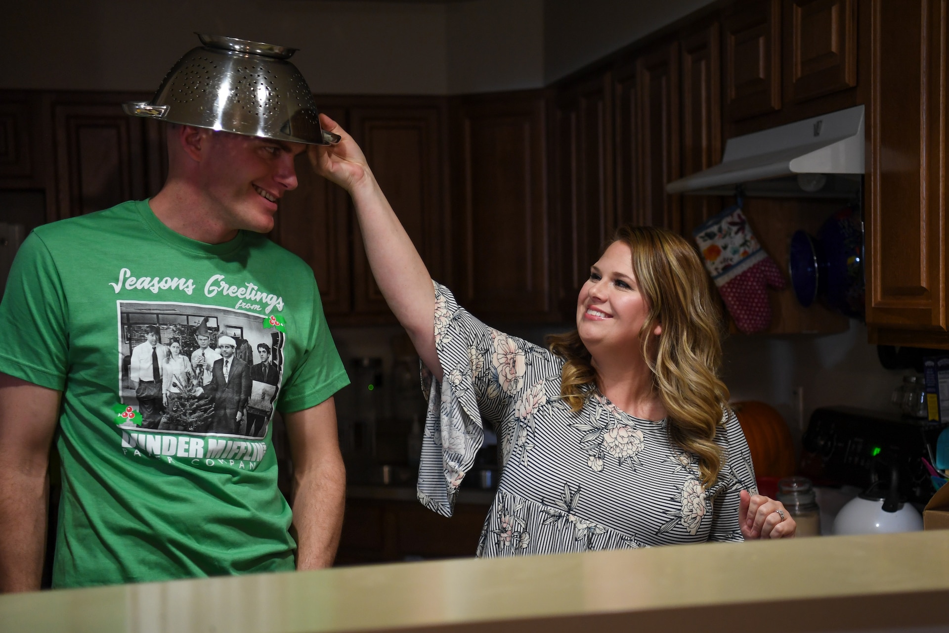 And man and woman stand near a sink
