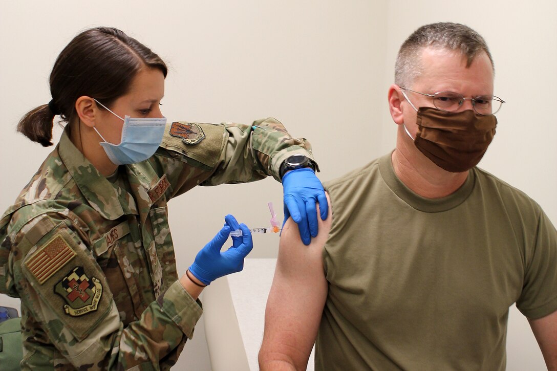 Tech. Sgt. Kirstin James, a medic with the 127th Medical Group, administers a COVID-19 immunization to Senior Master Sgt. Robert Sutton, a member of the 127th Security Forces Squadron, at Selfridge Air National Guard Base, Jan. 8, 2021. The 127th MDG began administering the vaccination at Selfridge ANGB to the base’s first responders and other mission-essential personnel. More widespread distribution of the vaccine to base personnel is scheduled throughout the month.