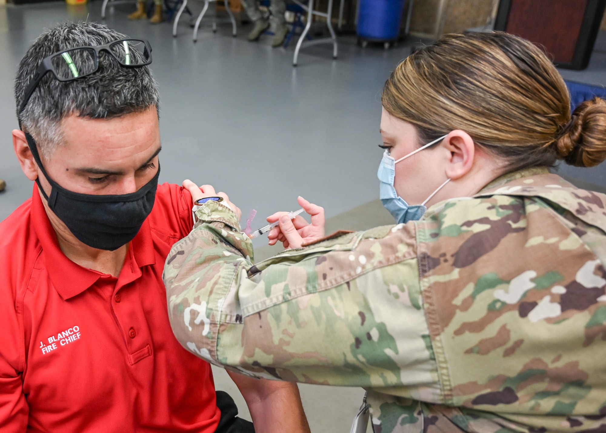 Javie Blanco, 775th Civil Engineer Squadron fire chief, receives his COVID-19 vaccination.