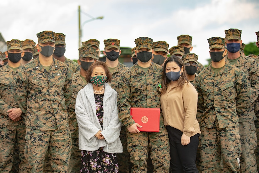 Marines stand with two women.