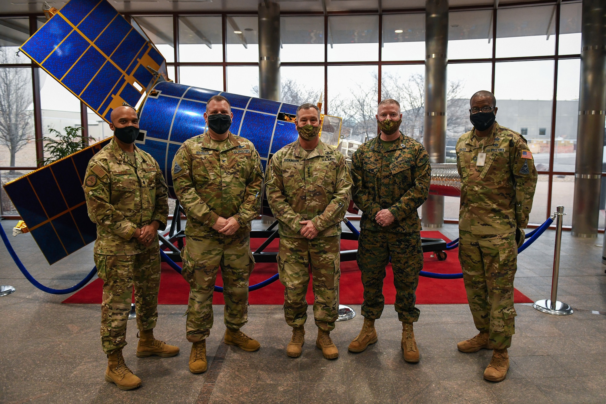 From left to right, U.S. Air Force Lt. Col. Trevor Hollis, Space Delta 4 deputy commander, U.S. Space Force Col. Richard Bourquin, DEL 4 commander, U.S. Army Gen. James Dickinson, U.S. Space Command commander, U.S. Marine Corps Master Gunnery Sgt. Scott H. Stalker, USSPACECOM senior enlisted leader, and U.S. Space Force Chief Master Sgt. Willie Frazier, DEL 4 senior enlisted leader, pose for a group photo in the Mission Control Station lobby on Buckley Air Force Base, Colo., Jan. 7, 2021.