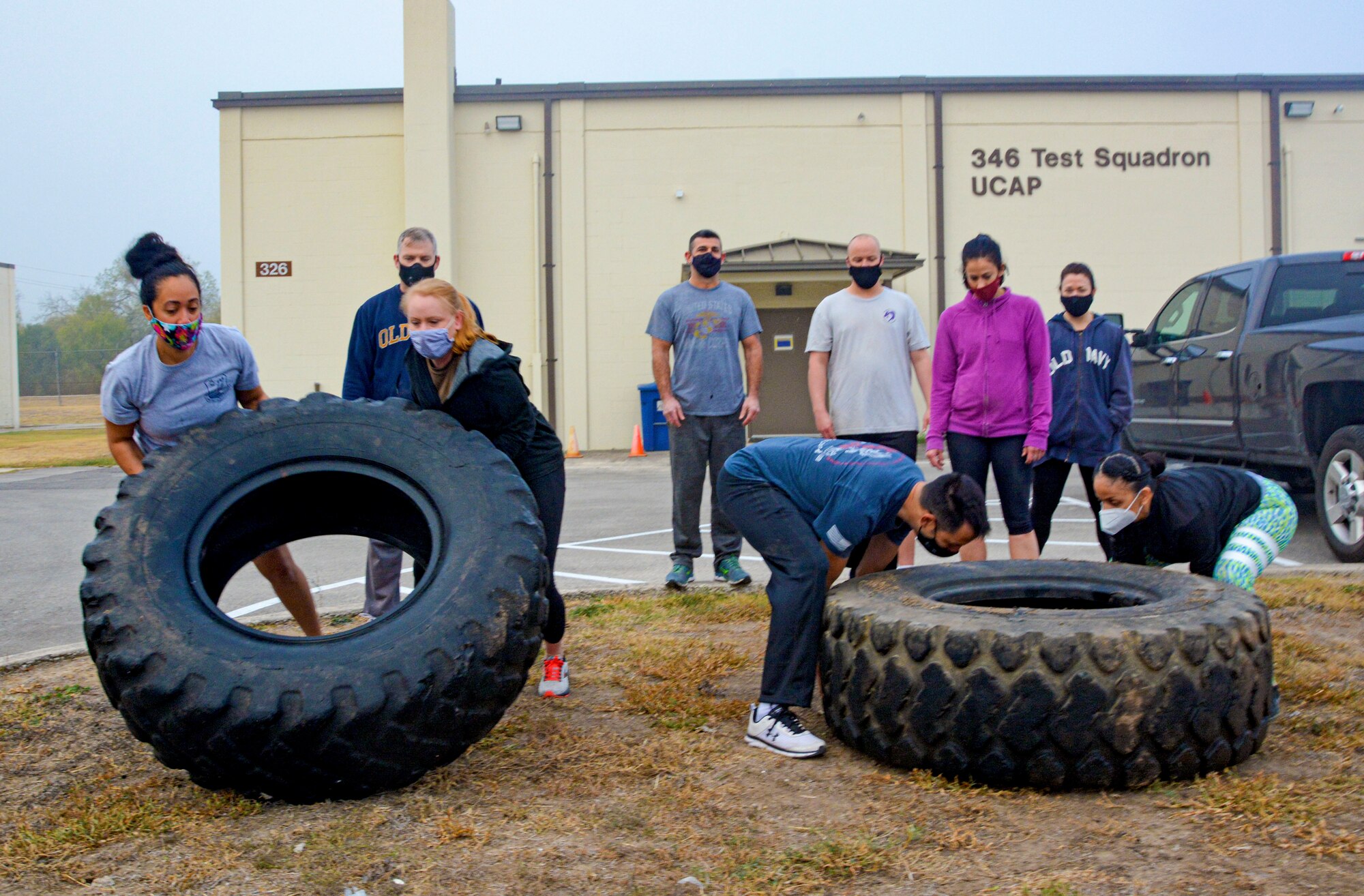 First sergeants of the 960th Cyberspace Wing lift tires Nov. 19, 2020, in a team building exercise during the wing leadership summit at Joint Base San Antonio-Chapman Training Annex, Texas. (U.S. Air Force photo by Samantha Mathison)