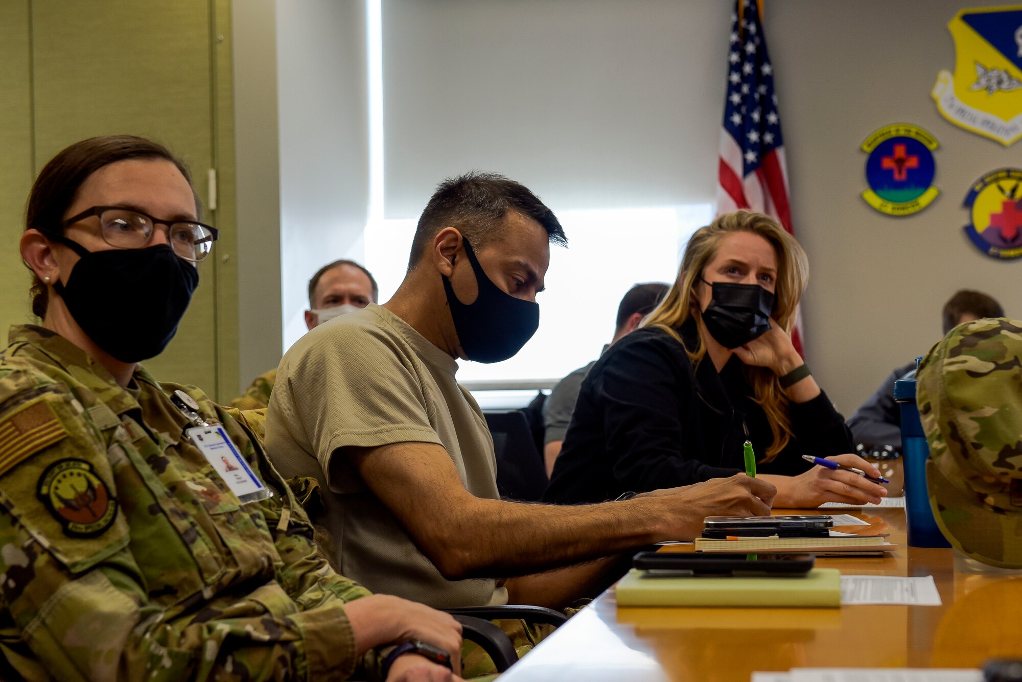 Members of the 27th Special Operations Wing read over medical forms before receiving the first batch of COVID-19 vaccines at Cannon Air Force Base, N.M., Jan. 7, 2021. 20 personnel were given the vaccine with more planned in the following days. (U.S. Air Force photo by Senior Airman Vernon R. Walter III)