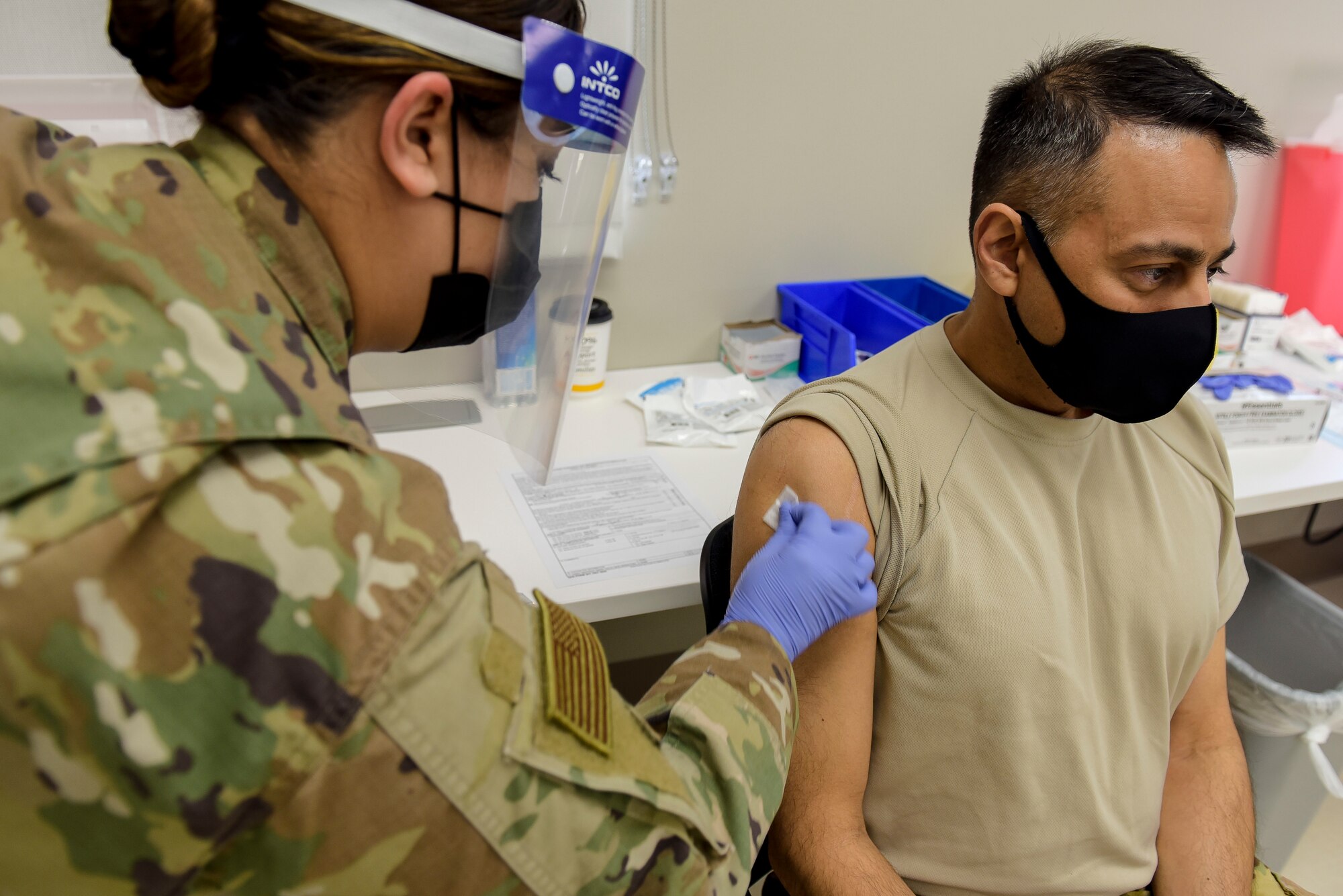 Staff Sgt. Melissa Hager, 27th Special Operations Medical Group immunizations clinic non-commissioned-officer-in-charge, swabs the arm of Col. Sanjay Gogate, 27 SOMDG commander, before administering the COVID-19 vaccine to him at Cannon Air Force Base, N.M., Jan. 7, 2021. During the process, members were given briefings before and after receiving their shots to help answer questions. (U.S. Air Force photo by Senior Airman Vernon R. Walter III)