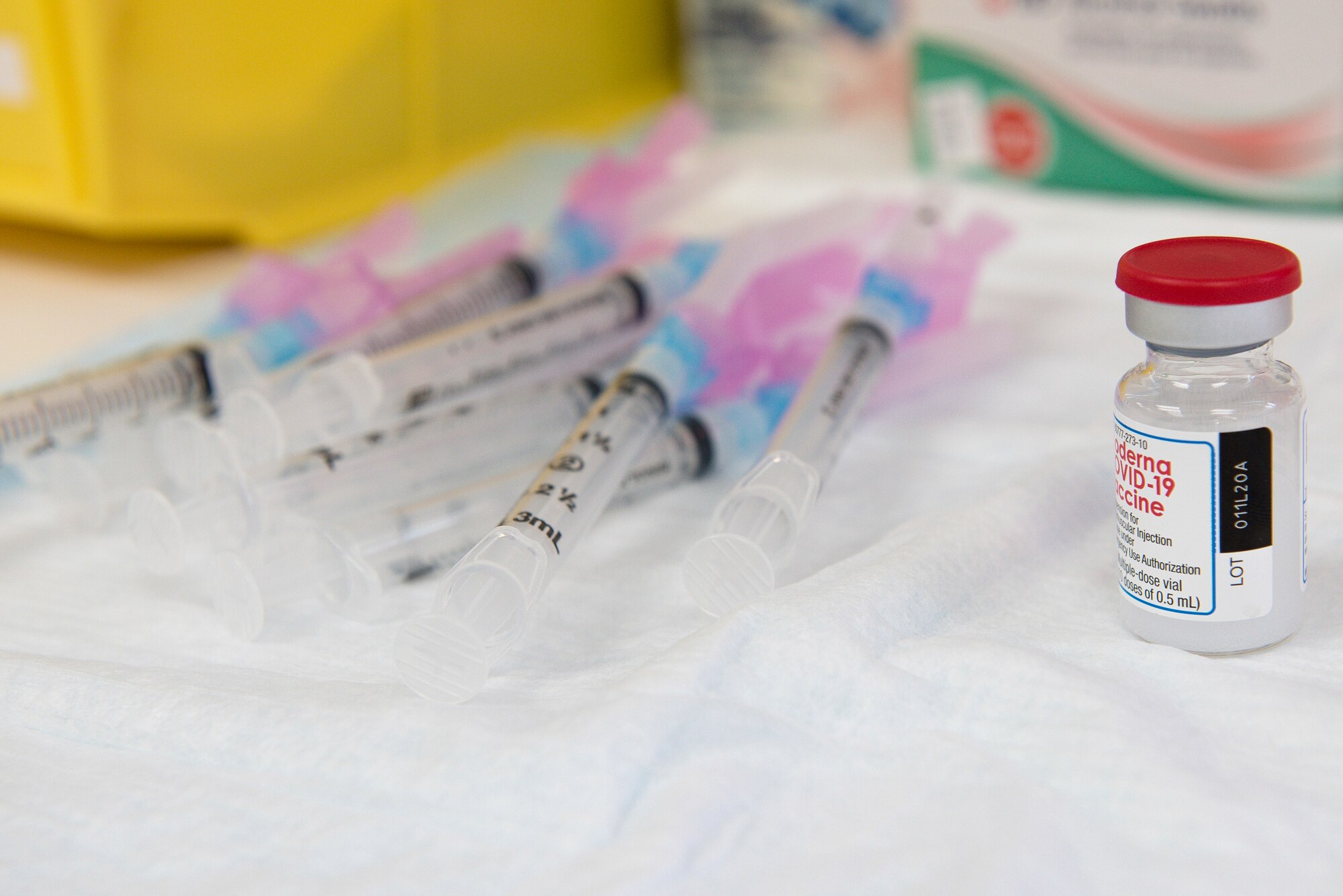 The COVID-19 vaccine and syringes lay on a table at the vaccination line at Cannon Air Force Base, N.M., Jan. 7, 2021. The vaccine distribution was handled by multiple members of the 27 SOMDG to ensure it was safely and properly delivered. (U.S. Air Force photo by Senior Airman Vernon R. Walter III)