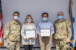 Dr. Raheel Khan and Mrs. Tammy Midkiff of the Pediatric Department of WVU Health Sciences Division pose with Maj. John Bishra and Maj. Neil Copeland, physicians assigned to the 130th Airlift Wing, after receiving the Employer Support of the Guard and Reserve (ESGR) Patriot Award during a ceremony held Jan. 8, 2021, at McLaughlin Air National Guard Base, Charleston, West Virginia. The Patriot Award recognizes supervisors and bosses nominated by a Guardsman or Reservist employee for the support provided directly to them. ( U.S. Air National Guard photo by Master Sgt. Eugene Crist )