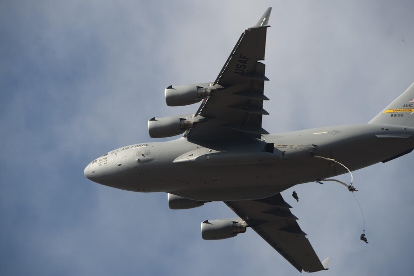 Parachutists descend just after jumping out of an aircraft.