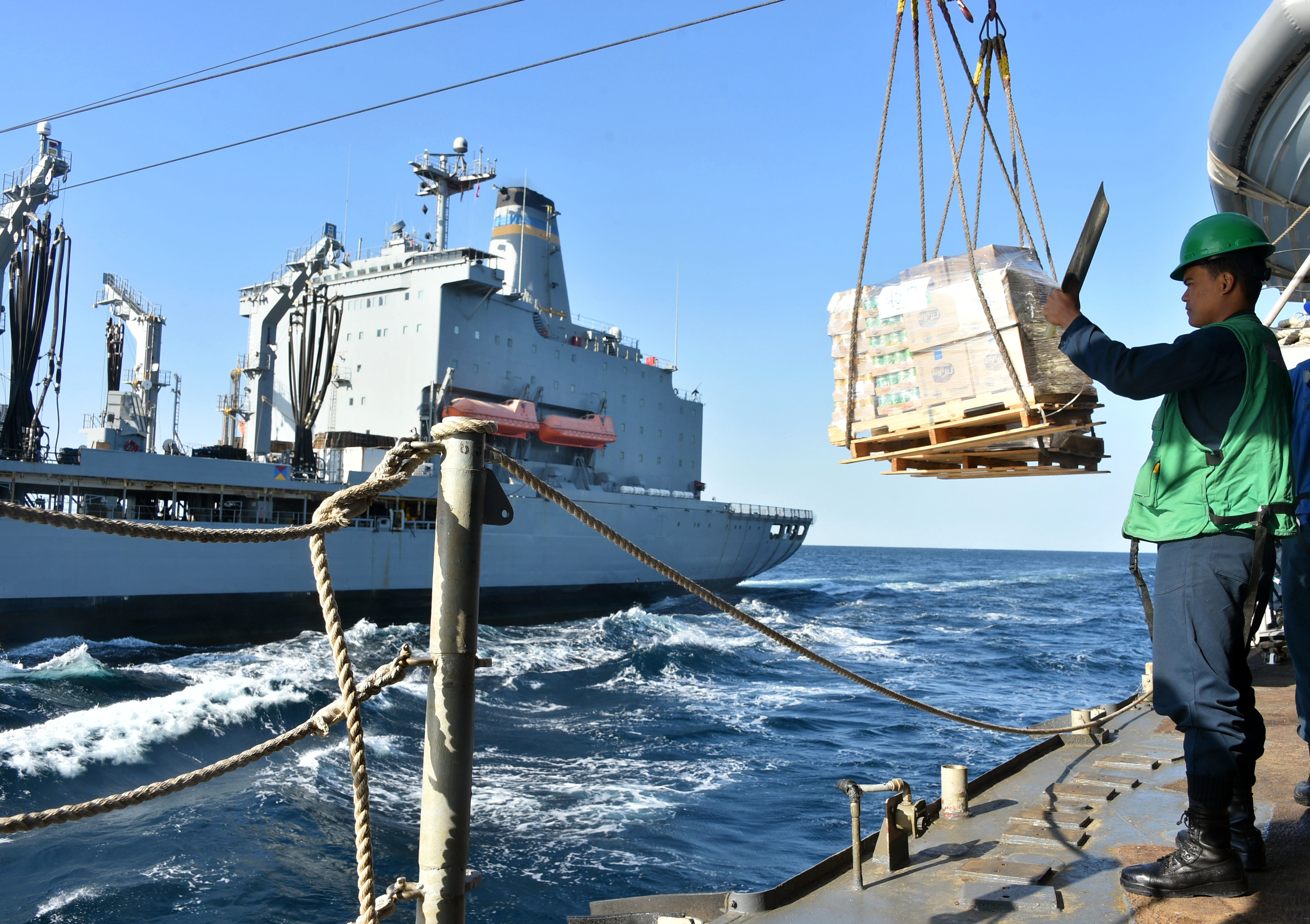USNS Leroy Grumman (T-AO 195), left, transfers supplies to the guided-missile cruiser USS Philippine Sea (CG 58) during a replenishment-at-sea in the Gulf of Oman.