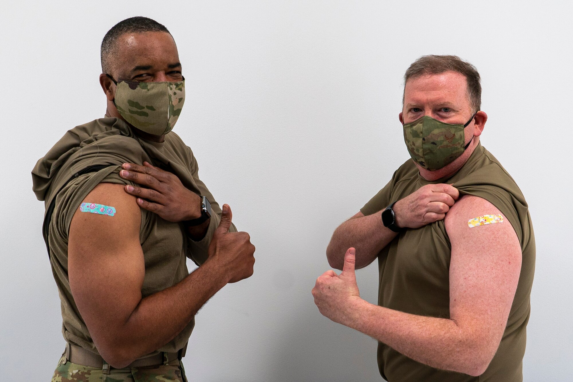 U.S. Air Force Lieutenant General Richard Scobee, chief of the Air Force Reserve and commander, Air Force Reserve Command, and Chief Master Sgt. Timothy White, senior enlisted advisor to the chief of the Air Force Reserve and command chief, Air Force Reserve Command, pose for a photo after receiving their Covid-19 vaccinations, January 8th, 2021 at Robins Air Force Base, GA. (US Air Force photo by Technical Sgt. Nicholas A. Priest)