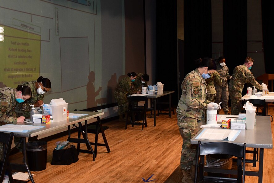 Airmen from 355th Medical Group prepare to vaccinate Airmen on base.