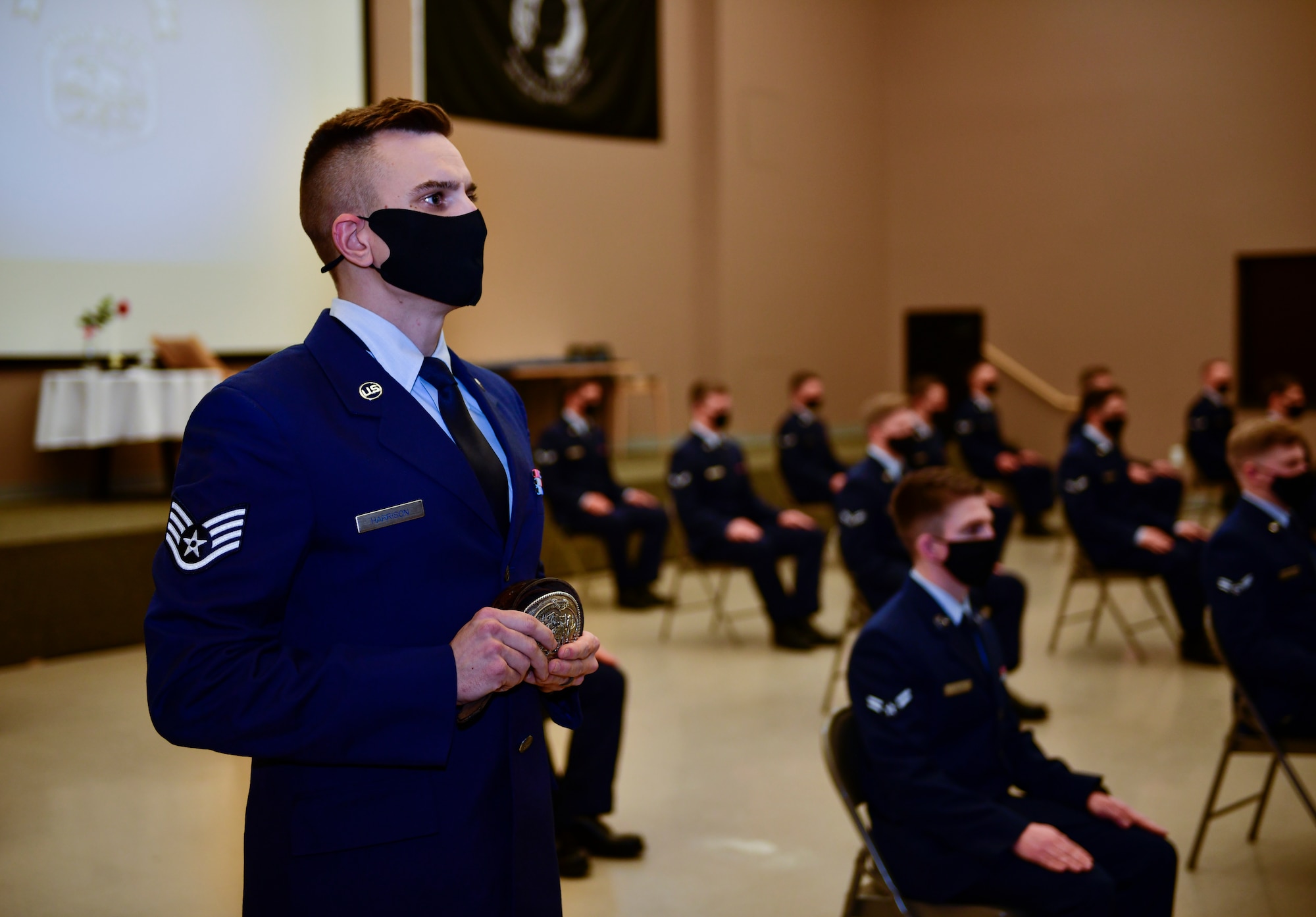 U.S. Air Force Staff Sgt. Dillon Harrison, 66th Training Squadron Survival, Evasion, Resistance and Escape specialist, holds the Fire Belt during a SERE Specialist Apprentice Course graduation ceremony at Fairchild Air Force, Washington, January 8, 2021. The belt is awarded to the student with the fastest fire craft time during training, and is a tribute to fallen SERE specialist, Master Sgt. Christopher Sheaffer. (U.S. Air Force photo by Senior Airman Ryan Gomez)