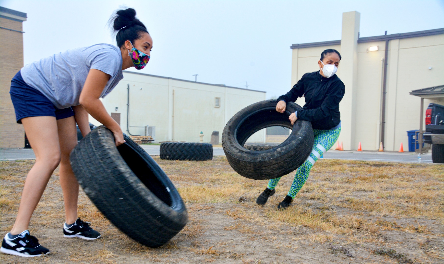 Master Sgts. Shatasha Estes, 55th Combat Communications Squadron first sergeant, and Jeanett Vielman, 50th Network Warfare Squadron first sergeant, throw tires during a team building exercise Nov. 19, 2020, during the 960th Cyberspace Wing leadership summit at Joint Base San Antonio-Chapman Training Annex, Texas. (U.S. Air Force photo by Samantha Mathison)