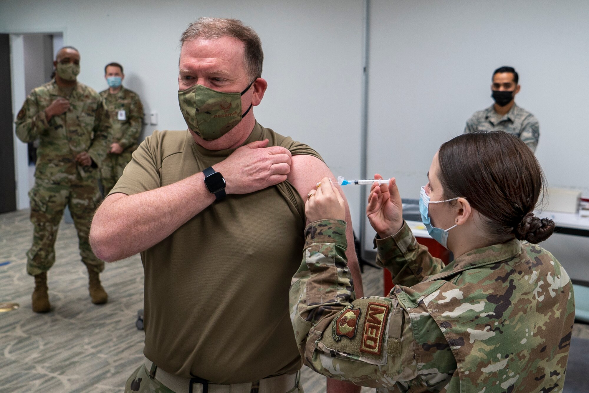 U.S. Air Force Reserve Senior Airman Megan Stahl, a medical technician with the 78th Healthcare Operations Squadron, administers the Covid-19 vaccine to Lieutenant General Richard Scobee, chief of the Air Force Reserve and commander, Air Force Reserve Command, January 8th, 2021 at Robins Air Force Base, GA. (US Air Force photo by Technical Sgt. Nicholas A. Priest)