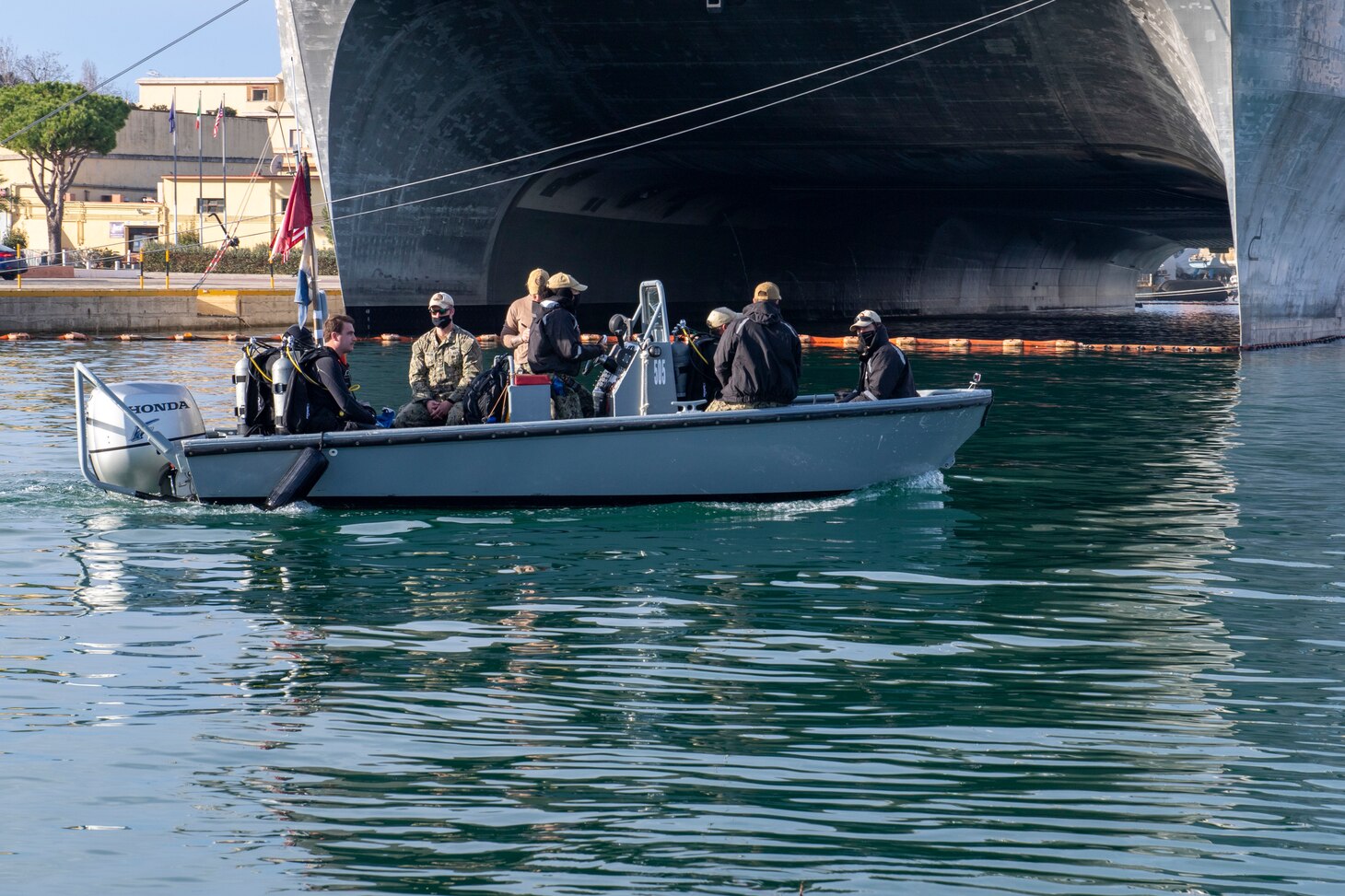 Underwater Construction Team (UCT) 1, from Virginia Beach, VA, move the spill containment barrier while utilizing the Norbit Multi-beam to conduct hydro-graphic survey in Gaeta, Italy, Dec. 15, 2020.