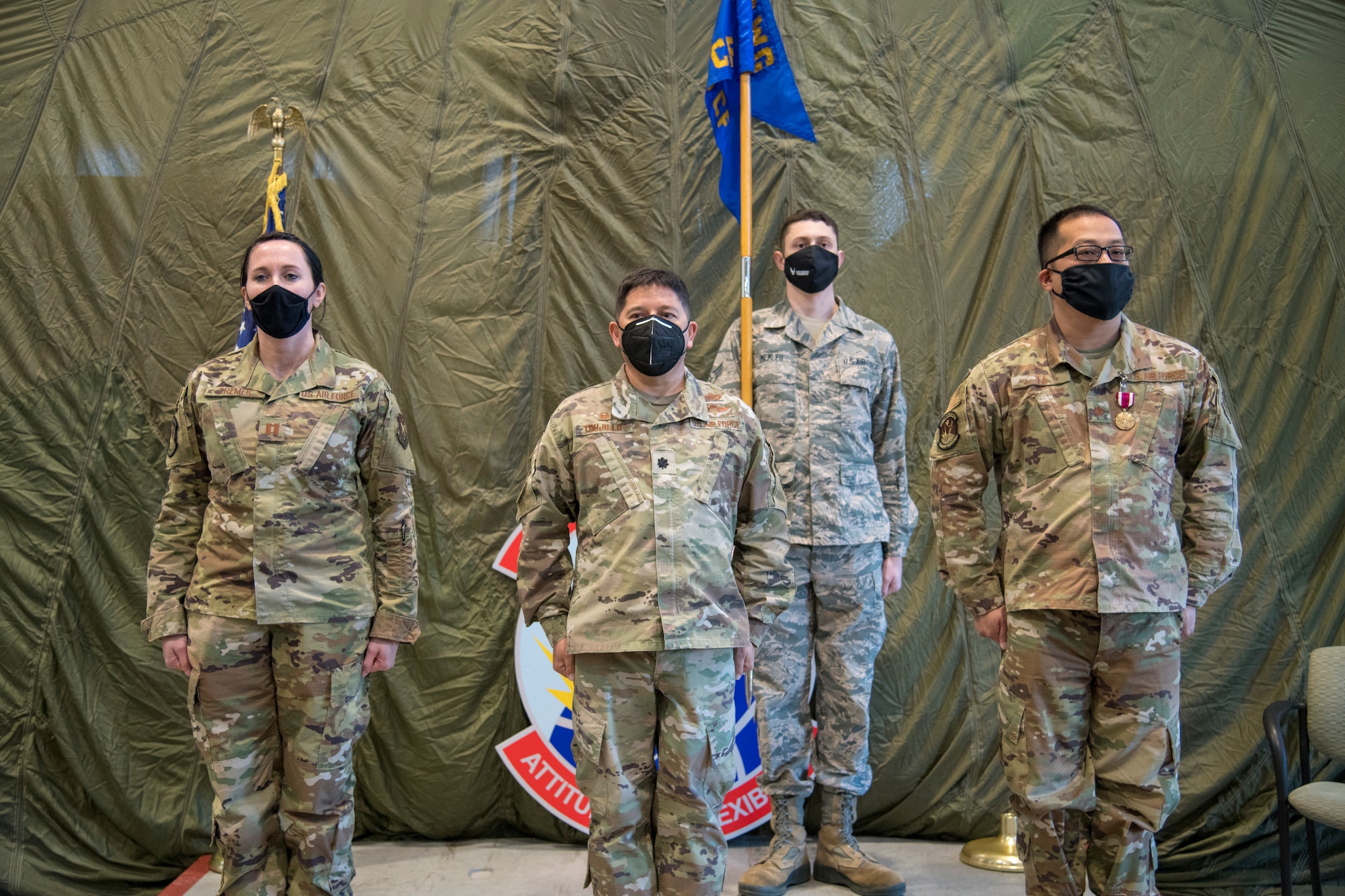 Reginald G. Trujillo, 403rd Mission Support Group commander, is flanked by outgoing 403rd Communications Flight commander Maj. Elvis Ta (right), and Capt. Cortney Tremer, incoming flight commander, as Senior Airman Robert Memleb holds the guidon during an assumption of command ceremony at the 41st Aerial Port Squadron January 9, 2021. The flight is responsible for providing the 403rd Wing with reliable, secure cyber communication systems and customer service to the near 1,400 Reserve Citizen Airmen. (U.S. Air Force photo by Senior Airman Kristen Pittman)