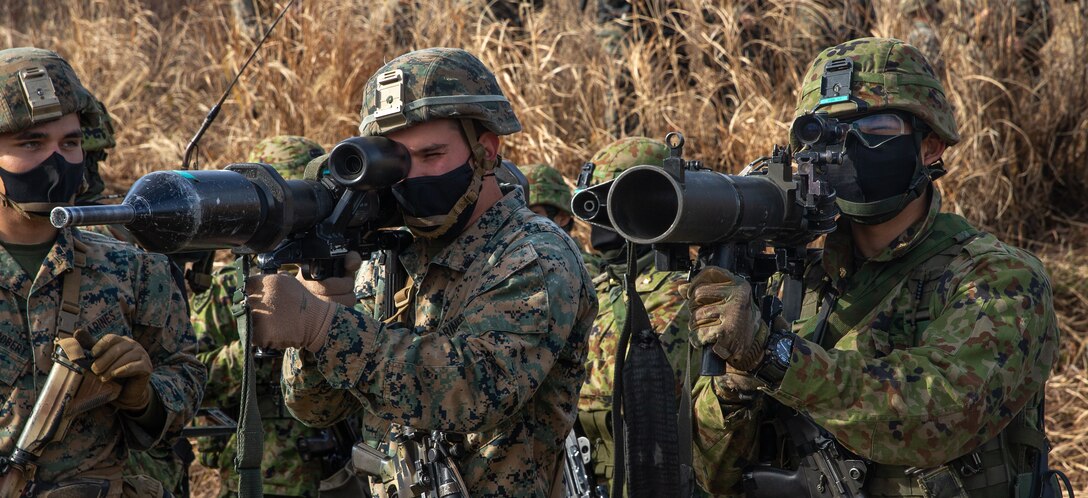 U.S. Marines with 3d Battalion, 8th Marine Regiment and troops from the 30th Infantry Regiment, 12th Brigade, Japan Ground Self-Defense Force examine each other’s anti-material weaponry